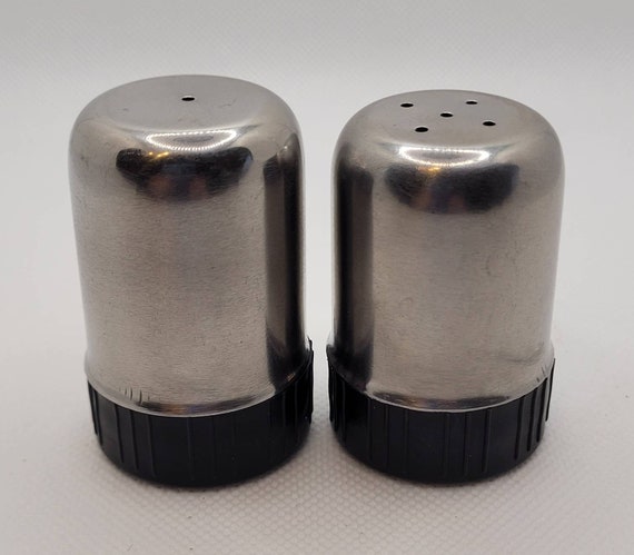 This salt shaker has one hole while the pepper shaker has multiple