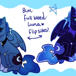 May include: Illustration of two cartoon ponies, one light blue and one dark blue, with wings and crescent moon symbols. The text reads "8cm full bleed Luna flip sides!" and the image is set against a light blue background with star accents.