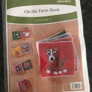 May include: A crochet book titled "On the Farm Book" by Herrschners. The book cover features a colorful illustration of a dog, a cow, a pig, a sheep, a turkey, a horse, and a rabbit.