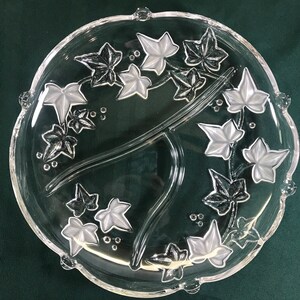 May include: A clear glass serving dish with three sections. The dish is decorated with an etched design of ivy leaves.