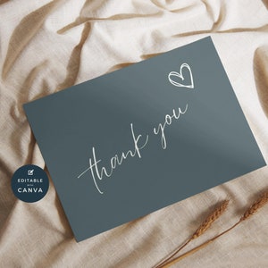 May include: A simple thank you card with a hand-drawn heart in white on a dark blue background. The card is editable with Canva.