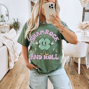 May include: A green t-shirt with a cartoon shamrock graphic and the text "Shamrock and Roll".