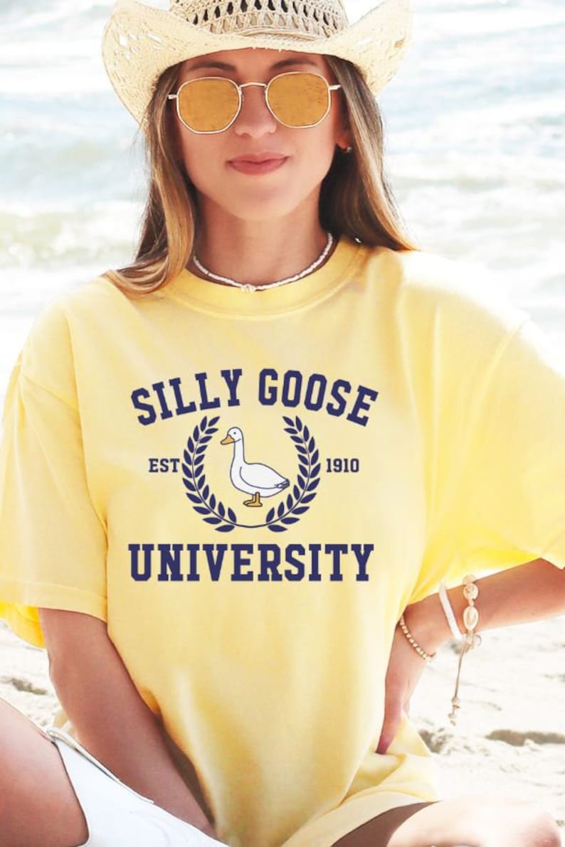 May include: A yellow t-shirt with a blue graphic of a duck and the text "Silly Goose University Est. 1910".