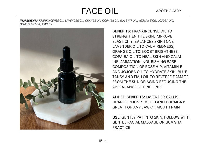 May include: A 15 ml bottle of face oil with a black dropper. The bottle is sitting on a white marble surface with green leaves. The label lists the ingredients and benefits of the oil, including frankincense, lavender, orange, copaiba, rose hip, vitamin E, jojoba, blue tansy, and emu oil.