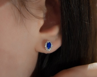 Pendientes de oro de 14 quilates con zafiro ovalado y halo de diamantes