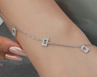Pulsera personalizada de oro de 14 quilates con inicial de diamante y delicado dije de letra.