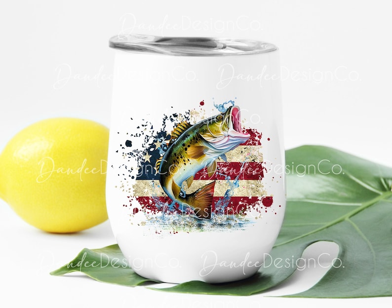 May include: White stainless steel wine tumbler featuring a graphic of a bass fish leaping from water against a backdrop of an American flag. The fish is green, brown, and yellow. The flag is red, white, and blue.