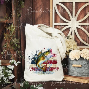 May include: A white tote bag featuring a design of a largemouth bass leaping from the water against a backdrop of an American flag. The design is in shades of red, white, and blue.