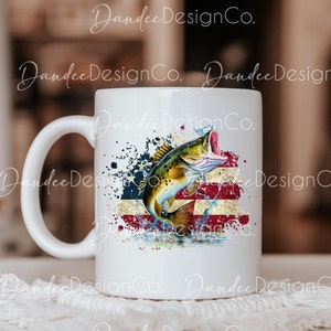 May include: White ceramic mug featuring a graphic of a bass leaping from the water in front of a distressed American flag design.