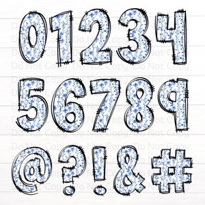 May include: Blue and white floral patterned numbers 0 through 9 and symbols @, ?, !, &, #. The numbers and symbols are outlined in black and have a stitched look.