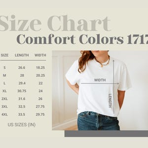 May include: A white t-shirt with a size chart for Comfort Colors 1717. The chart shows measurements in inches for sizes S through 4XL. The model is wearing a white t-shirt and blue jeans.
