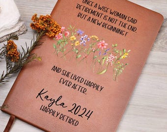 Può includere: Un diario in pelle marrone con un design floreale e il testo "Once a wise woman said 'Retirement is not the end, but a new beginning!'". Il diario contiene anche il testo "And she lived happily ever after. Kayla 2024 Happily Retired".