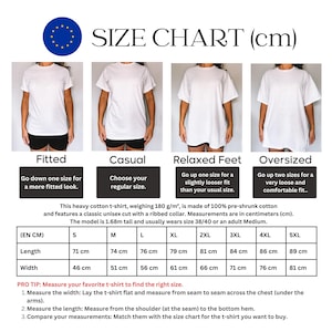 May include: A white t-shirt size chart with measurements in centimeters. The chart shows different fits: fitted, casual, relaxed, and oversized. Includes length and width measurements for sizes S to 5XL. The t-shirt is made of 100% pre-shrunk cotton.