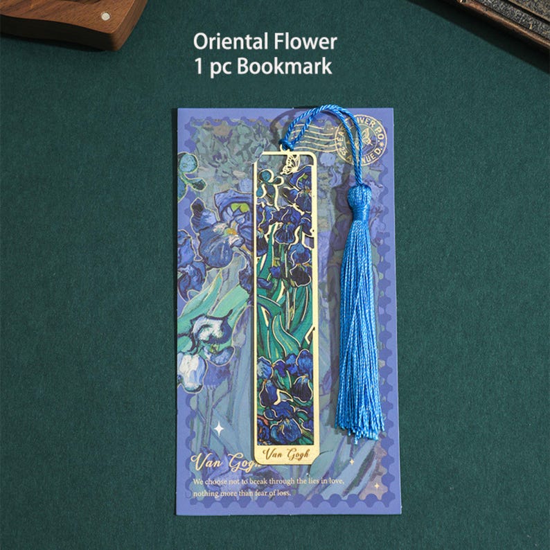 May include: A gold bookmark with a blue and green floral design. The bookmark has a tassel and the text "Van Gogh" on it. The bookmark is on a blue background with the text "Oriental Flower 1 pc Bookmark".