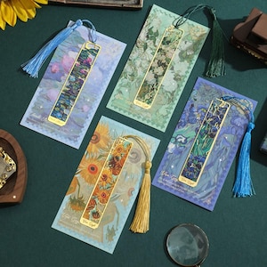 May include: Four gold metal bookmarks with colorful images and tassels. The bookmarks feature famous paintings by Vincent van Gogh, including Starry Night, Sunflowers, and Irises. Each bookmark has a gold tassel.