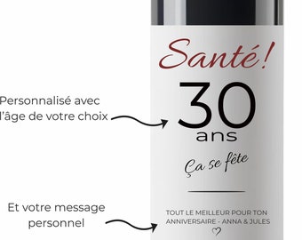 May include: A white wine bottle label with black text that reads "Santé! 30 ans Ça se fête" and "TOUT LE MEILLEUR POUR TON ANNIVERSAIRE - ANNA & JULES".