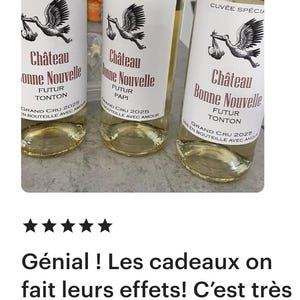 May include: Three bottles of white wine with a stork design and the text "Ch&acirc;teau Bonne Nouvelle" on the label. The bottles are labeled with "Futur Tonton", "Futur Papi", and "Futur Tonton".