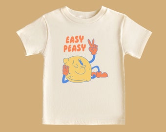 May include: A white t-shirt with a cartoon lemon wearing a peace sign and the text "Easy Peasy" printed on it.