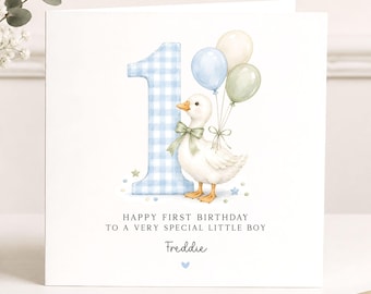 May include: A square greeting card featuring a large blue gingham number one, a white duckling with a green bow, and three balloons in blue, cream, and green. Text reads: HAPPY FIRST BIRTHDAY TO A VERY SPECIAL LITTLE BOY and Freddie.
