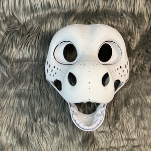 May include: White unpainted furry animal head base with open mouth and visible teeth. The base has large eye sockets and a textured nose.