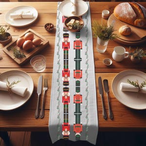 May include: White table runner with a repeating pattern of nutcracker soldiers in red, green, and black. The nutcrackers are holding a sword and have a mustache. The pattern is bordered by green leaves.
