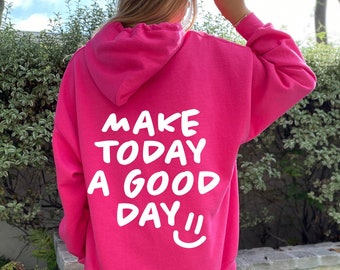 May include: Pink hoodie with a white graphic that says "Make Today a Good Day" and a smiley face.