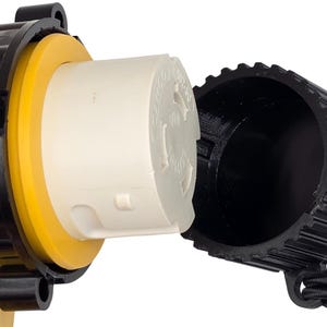 May include: A yellow and black electrical adapter with a white plug. The adapter has a black cap attached with a black cord. The plug is white with a circular design.
