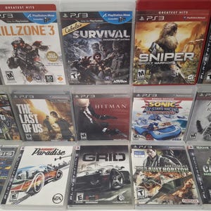 May include: A collection of 15 video game cases for the Playstation 3 console. The cases are arranged in three rows of five. The games include titles such as "Killzone 3", "Grand Theft Auto IV", "The Last of Us", "Call of Duty 4: Modern Warfare", and "Assassin's Creed: Revelations".