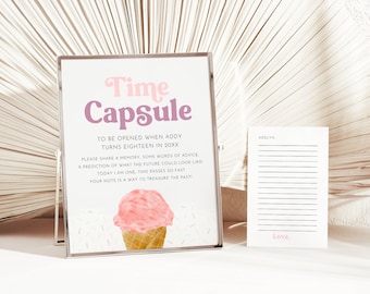 May include: A white sign with the text "Time Capsule" in pink and purple letters. The sign says "To be opened when Addy turns eighteen in 20XX".  The sign also includes instructions for writing a note for a time capsule.  The sign has a pink and white ice cream cone with sprinkles on it.  A white card with lines for writing and the text "Adelyn" and "Love." is next to the sign.