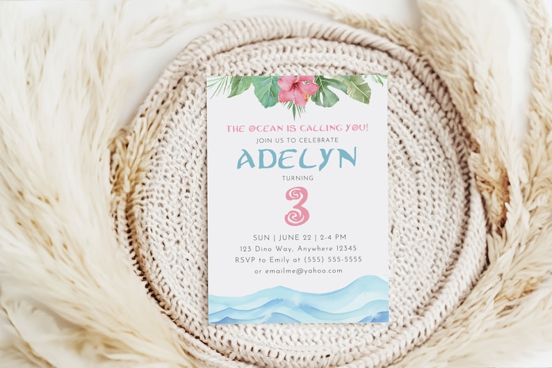 May include: A light blue and pink birthday invitation with a watercolor design of ocean waves and tropical flowers. The invitation says "The ocean is calling you!" and "Join us to celebrate Adelyn turning 3". It includes the date, time, and location of the party, as well as RSVP information.