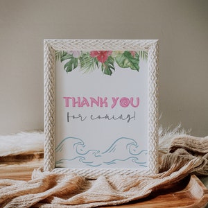 May include: White framed sign with a tropical floral border and the text "THANK YOU for coming!" in pink and blue lettering. The sign also features a blue wave design.
