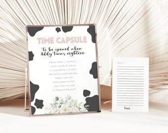 May include: A black and white cow print sign with the text "TIME CAPSULE" in pink letters. The sign says "To be opened when Addy turns eighteen. Please share a memory, some words of advice or a prediction of what the future could look like. Today I am one. Time passes so fast, your note is a way to treasure the past!"  A white lined card with the text "Addy" and "Love," is next to the sign.
