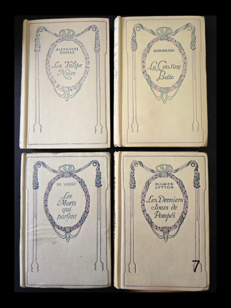 May include: Four antique books with cream covers. Each book has a decorative oval design and French text. Titles include "La Tulipe Noire," "La Cousine Bette," "Les Morts qui parlent," and "Les Derniers Jours de Pomp&eacute;i."