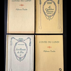 May include: Four vintage books with cream covers are shown. The titles and authors are printed in black and red. The books include "Contes du Lundi" by Alphonse Daudet, "Le Capitaine Fracasse Tome II" by Th&eacute;ophile Gautier, and "Les Amants de Pise" by Peladan.