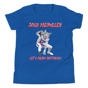 May include: A royal blue youth t-shirt with the text "Josh Meowllen" and "Let's Meow Buffalo!!!" in red. A cartoon image of a cat wearing a football uniform is in the center of the shirt.