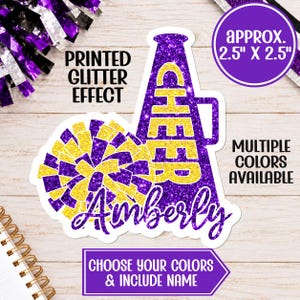 May include: A sticker featuring a purple and yellow glitter-effect megaphone with the word CHEER and a matching pom-pom. The name Amberly is written in purple script. Text includes PRINTED GLITTER EFFECT, APPROX. 2.5" X 2.5", MULTIPLE COLORS AVAILABLE, and CHOOSE YOUR COLORS & INCLUDE NAME.