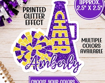 May include: A sticker featuring a purple and yellow glitter-effect megaphone with the word CHEER and a matching pom-pom. The name Amberly is written in purple script. Text includes PRINTED GLITTER EFFECT, APPROX. 2.5" X 2.5", MULTIPLE COLORS AVAILABLE, and CHOOSE YOUR COLORS & INCLUDE NAME.