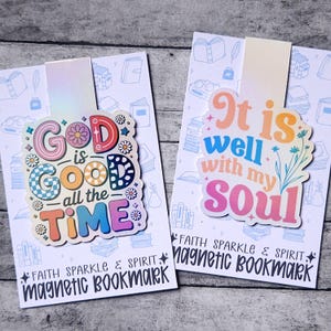 May include: Two magnetic bookmarks with inspirational quotes. One says "God is Good all the Time" in colorful letters. The other says "It is well with my Soul". Both have the words "Faith Sparkle & Spirit" and "Magnetic Bookmark" printed on them.