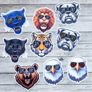 May include: Ten colorful animal stickers with the text "Game Day" on each. The stickers feature a variety of animals, including a tiger, a bear, a bulldog, a panther, and an eagle. The stickers are perfect for adding a fun and festive touch to any game day party.