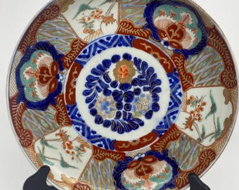 Charge imari plate, floral and geometric design.