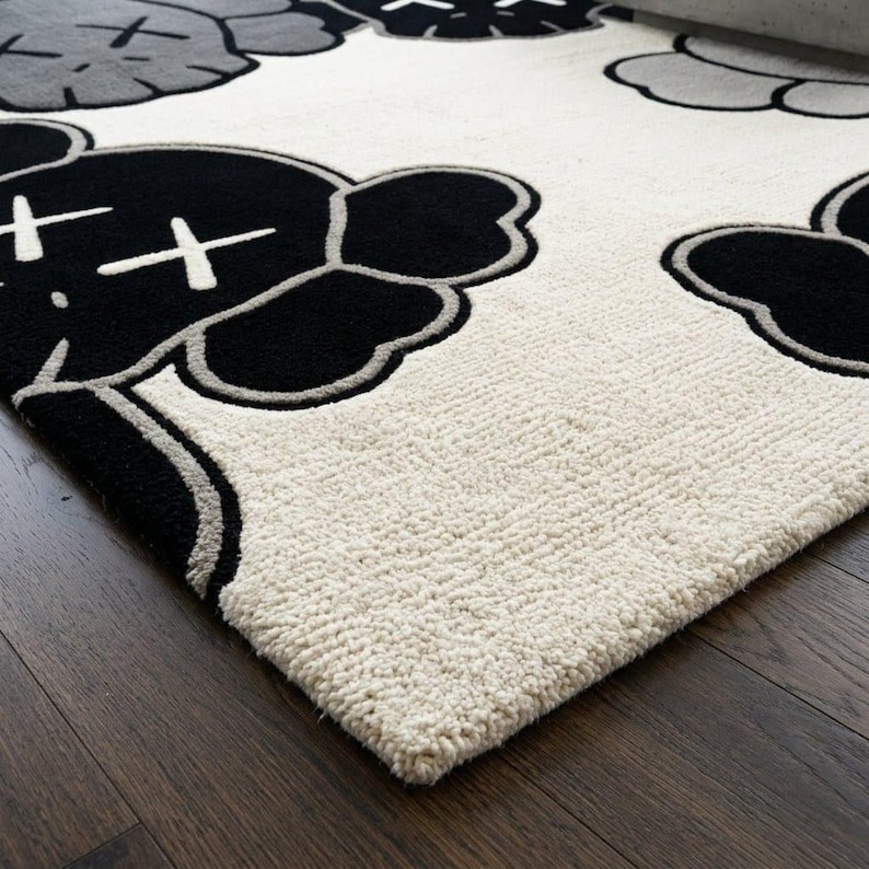 Detailed macro shot of a greyscale pop art character rug highlighting the thick, plush hand-tufted wool fibers, clean scissor-carving outlines, and contrasting black, grey, and cream textures by Crafted Treads Rugs.