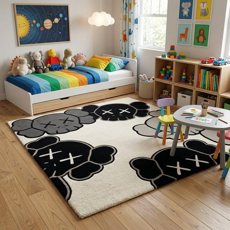 A playful greyscale cartoon character tufted wool rug styled on a light oak wood floor in a bright, modern kids' bedroom next to colorful toys, a white bed, and wooden shelves.