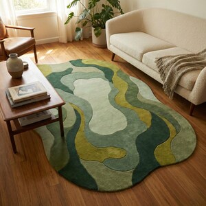 Organic modern hand-tufted wool rug in layered green abstract shapes with sculptural edges, styled in a warm minimalist living room.