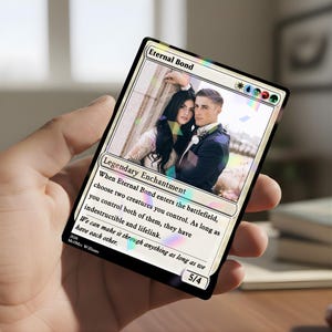 May include: A custom "Eternal Bond" Magic: The Gathering card featuring a wedding photo. The card has a white border with text that reads "Legendary Enchantment" and a quote. The card is held in a hand.