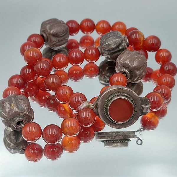 Old necklace of carnelian beads with a silver clasp