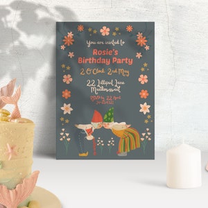 May include: A blue birthday party invitation with a floral border. The invitation features a cartoon illustration of two gnomes with a text that reads "You are invited to Rosie's Birthday Party 2 o'clock 2nd May 22 Jilliput Jane Meadowswed RSVP by 22 April 0654321".