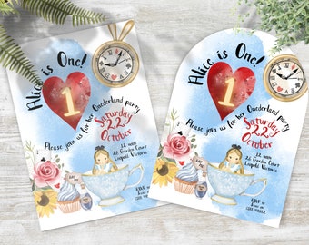 May include: Two Alice in Wonderland themed first birthday party invitations. The invitations are printed on white cardstock with blue watercolor backgrounds. One invitation is a rectangle and the other is an arch. Both invitations feature a red heart with a white "1" inside, a pocket watch, and a teacup with Alice sitting inside. The text on the invitations reads "Alice is One!" and "Onederland party Saturday 2.2.2 October 12 noon 26 Garden Court Leopold Victoria RSVP Jessie on 0000 000000".