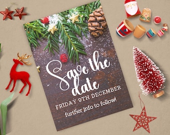 May include: Save the date card featuring a wintery pine bough and pine cone on a wood background. The text reads "Save the date" in a white cursive font. Below the text is "Friday 9th December" and "further info to follow!"