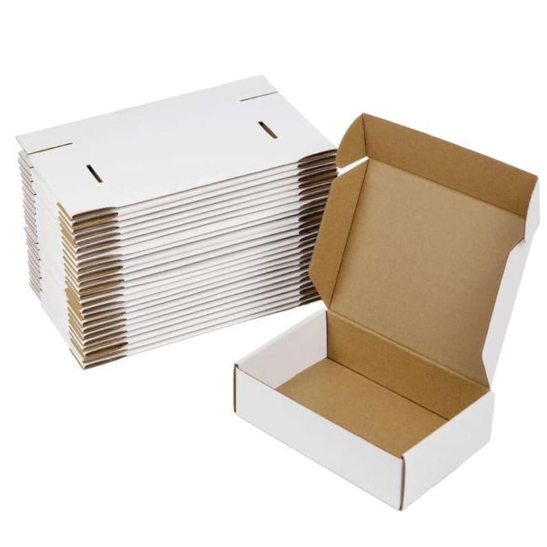 May include: A stack of flat, white cardboard shipping boxes alongside one fully assembled open box. Each box features a white exterior and a natural brown interior, with pre-cut folding lines and slots for secure closure during assembly.