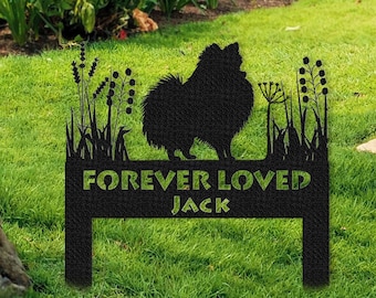May include: Black metal silhouette of a dog with the words "Forever Loved Jack" on a metal sign in a grassy yard.